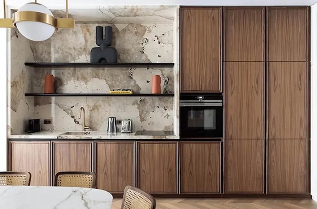 Modern kitchen with wooden cabinets, marble backsplash, floating shelves, and built-in oven