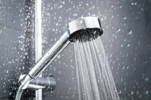 Close-up of shower head with running water showing modern bathroom fixture